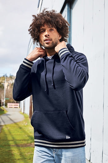 A shot of a man wearing New Era® Comeback Fleece Pullover Hoodie.