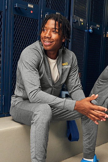 Men at a sporting game wearing Sport-Tek Sport-Wick® Stretch Full-Zip Cadet Jacket.