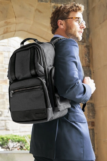 A shot of a man carrying Brooks Brothers Grant Backpack.