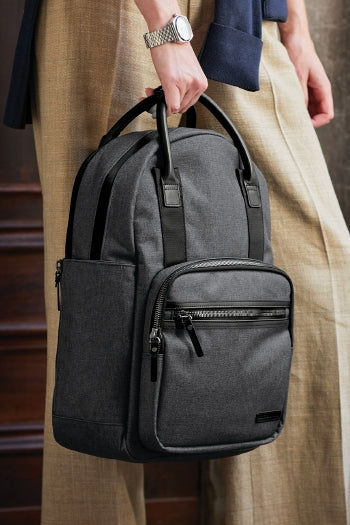 A shot of a man carrying Brooks Brothers Grant Dual-Handle Backpack
