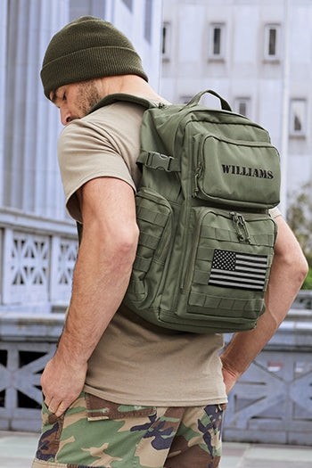 Back view shot of a man carrying CornerStone® Tactical Backpack in the city.