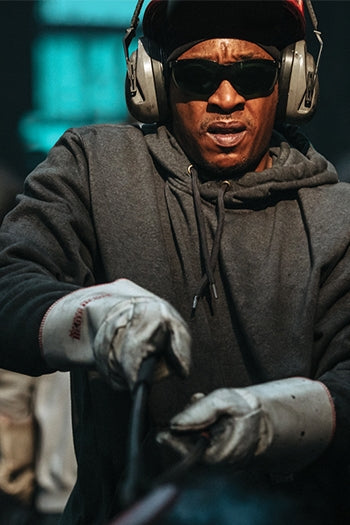 A shot of a man wearing Carhartt Rain Defender Paxton Heavyweight Hooded Sweatshirt.