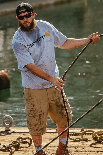 A shot of a man wearing Carhartt Rugged Flex® Rigby Cargo Short.