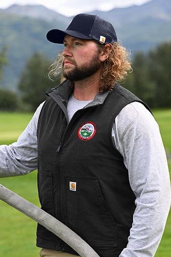 Shot of a man wearing Canvas Mesh Back Cap at a jobsite.