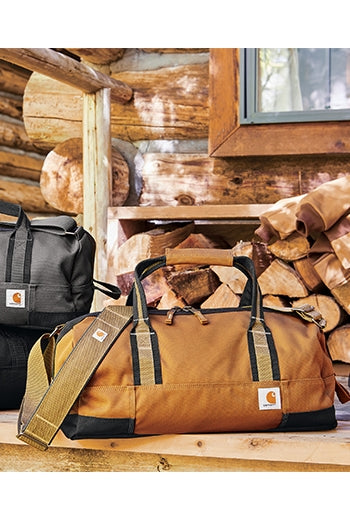 A duck brown Carhartt® Foundry Series 20” Duffel on a table.