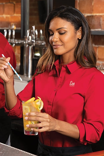 A shot of a woman wearing Port Authority Ladies Long Sleeve SuperPro React ™.