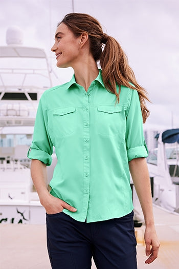A shot of a woman wearing Port Authority Women's Long Sleeve UV Daybreak Shirt.