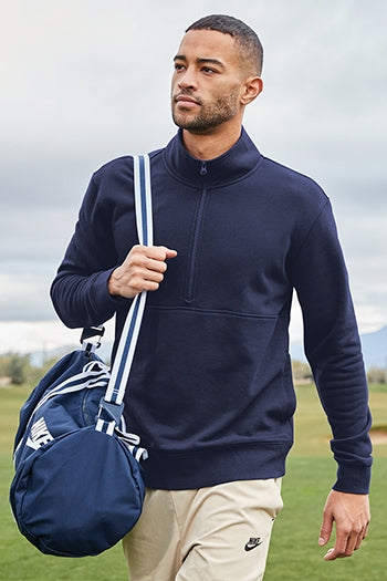 A shot of a man wearing Nike Club Fleece Sleeve Swoosh 1/2-Zip at a golf course.