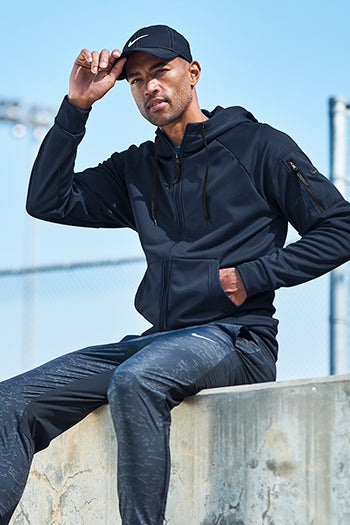A shot of a man wearing Nike Therma-FIT Pocket Full-Zip Fleece Hoodie.