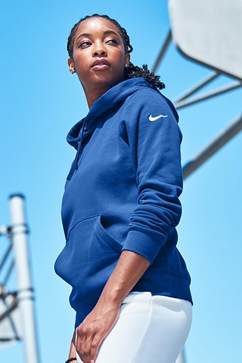 A shot of a woman wearing Nike Women's Club Fleece Sleeve Swoosh Pullover Hoodie.